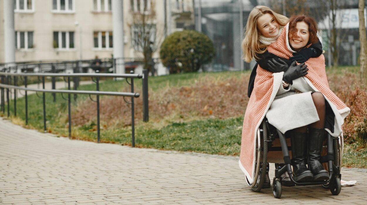 Dwie kobiety na wózkach inwalidzkich na chodniku.